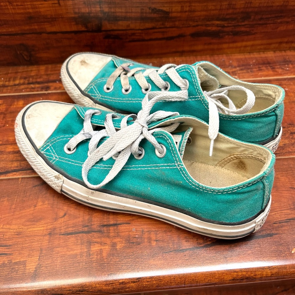 Teal converse women’s low tops.